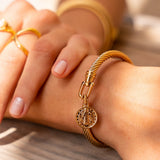 Gold bracelet with a coin motif