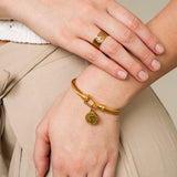 Gold bracelet with a coin motif